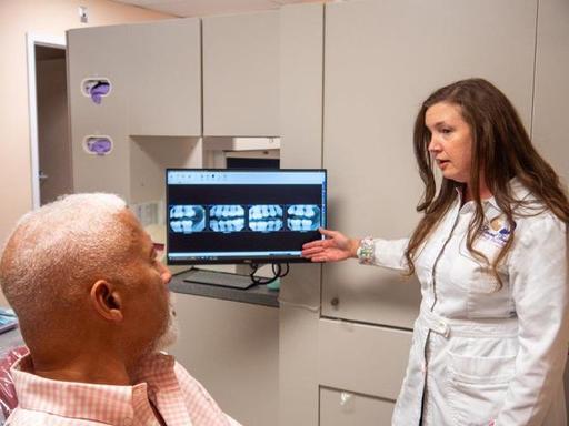 Dentist explaining digital dental X-rays to a pati